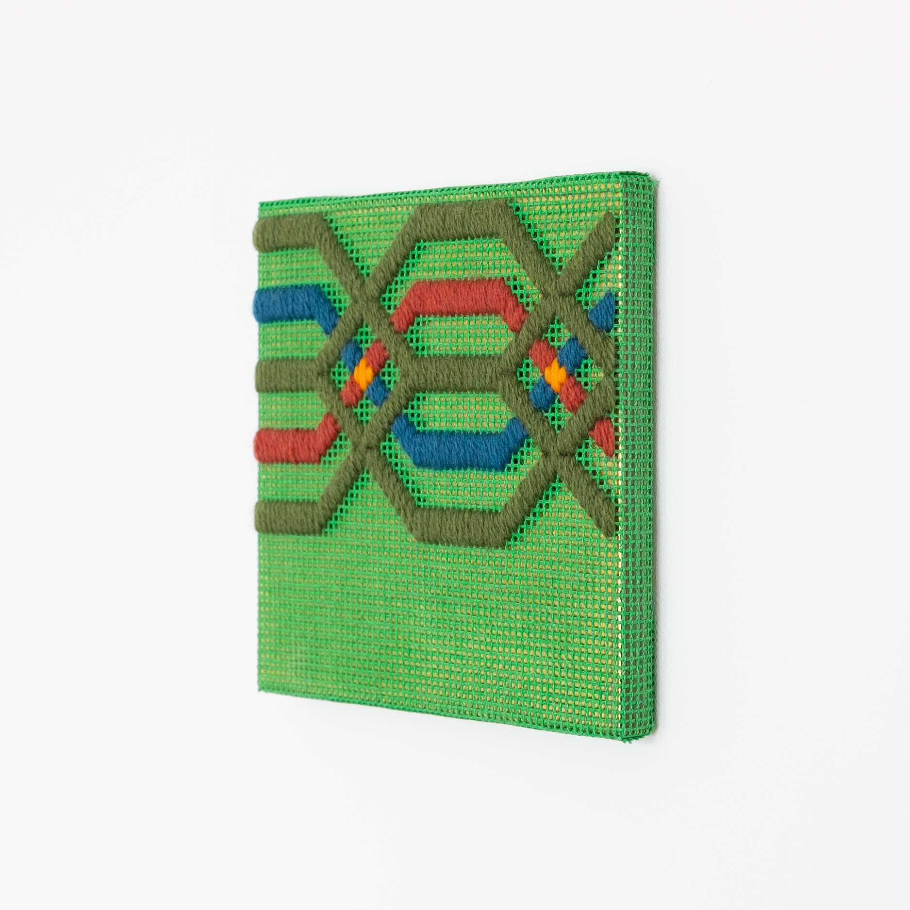 Border fragment [olive-red-blue on green], Hand-embroidered wool thread and acrylic paint on canvas over gilded panel, 2021