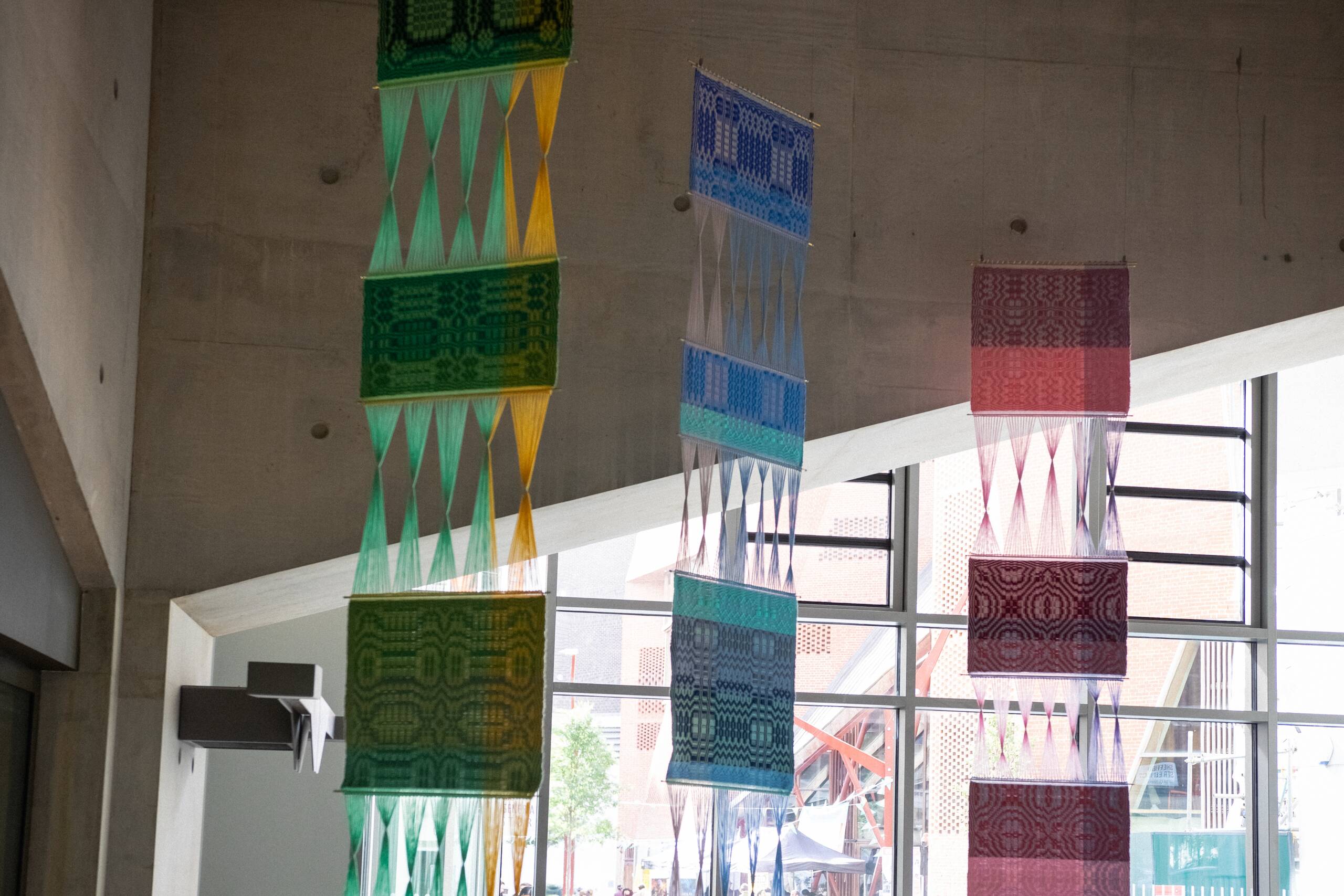 Interaction of pattern [systems of influence in red, green, & blue], Hand-woven cotton yarn, brass, aluminum (commissioned by Artiq, permanent installation at London School of Economics Marshall Building), 2022