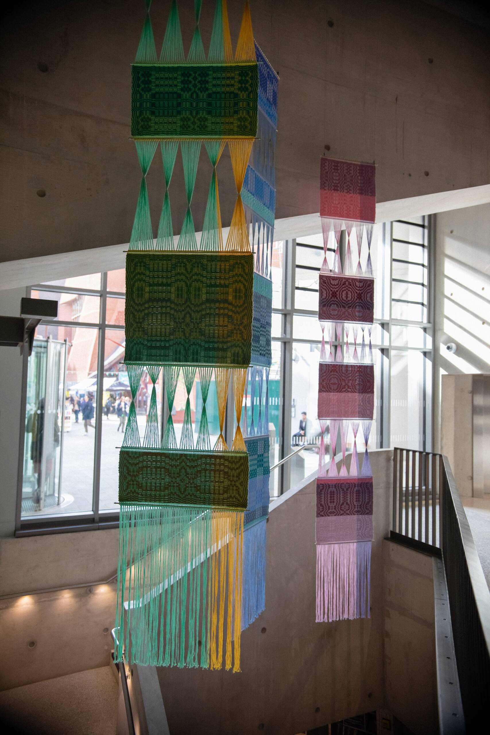 Interaction of pattern [systems of influence in red, green, & blue], Hand-woven cotton yarn, brass, aluminum (commissioned by Artiq, permanent installation at London School of Economics Marshall Building), 2022